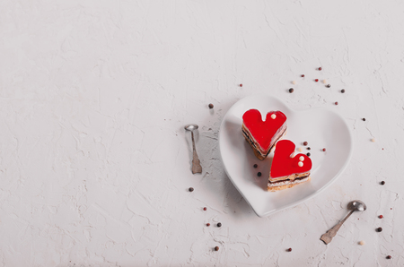 Two jelly heart-shaped cakes on white concrete background. Free space for your text. Toned effect.の写真素材