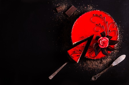 Red Cake with rose on black background. Top view. Valentine's Day.の写真素材