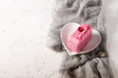 Pink cupcakes, spoon under morning sun on grey runner and white backgroundの写真素材