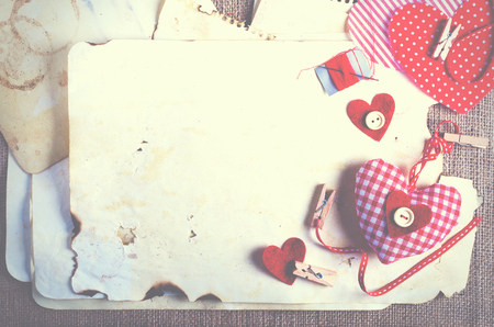 Red polka dot textile hearts on burlap. Free space for your textの写真素材