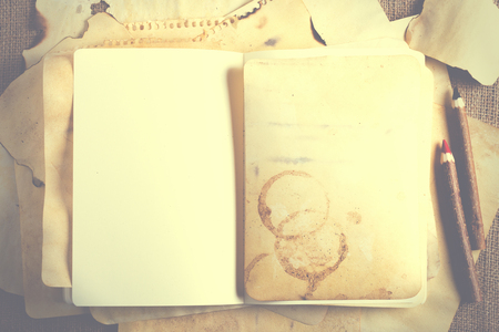 Stack old papers and notebook on burlap, sackcloth background. Vintage and retro design effects.の写真素材
