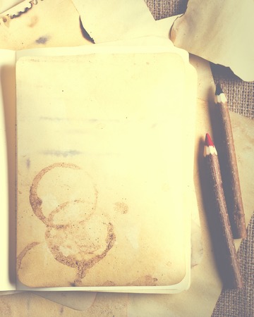 Stack old papers and notebook on burlap, sackcloth background. Vintage and retro design effects.の写真素材
