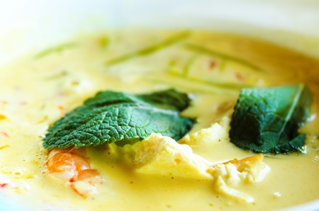 Spicy coconut milk cream soup curry with chiken, tiger prawns, long soy noodles, bean sprouts, lime, chilli pepper and mint. Asian traditional national cuisine, recipe. Copy space.の写真素材