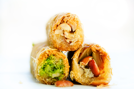 Turkish dessert - Baklava with peanut, pistachious, honey on white background. Healthy sweets. Copy space.の写真素材