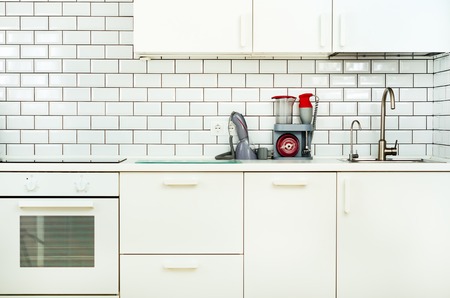 White interior design, modern and minimalist style kitchen with household appliances. Open space in living room full of light. Copyspace.の写真素材