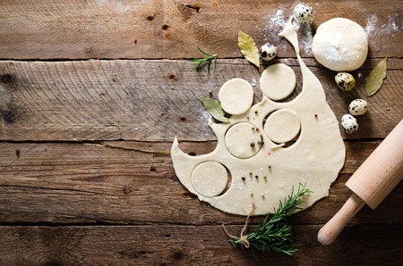 Preparing, cooking, making homemade ravioli, pelmeni or dumplings with meat on wooden table top view. Top view. Rustic style.の写真素材