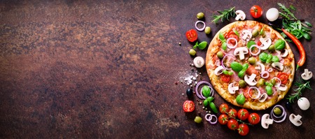 Food ingredients and spices for cooking delicious italian pizza. Mushrooms, tomatoes, cheese, onion, oil, pepper, salt, basil, olive on rustic background. Copyspace. Top view. Bannerの写真素材