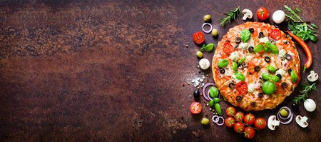 Food ingredients and spices for cooking delicious italian pizza. Mushrooms, tomatoes, cheese, onion, oil, pepper, salt, basil, olive on rustic background. Copyspace. Top view. Bannerの写真素材