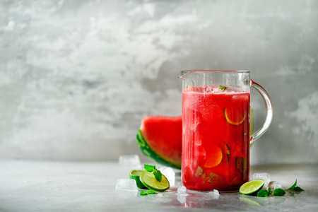 Detox water with watermelon, lime, mint and ice on light background, copy spaceの写真素材