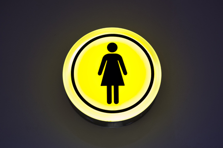 Toilet female signs on the abstract wall background. Copy space. Woman gender conceptの写真素材