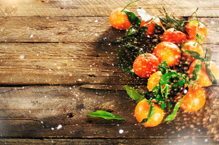 Mandarins Tangerines on wooden background. Copy space for your text. Bokeh and lights, toned effectの写真素材