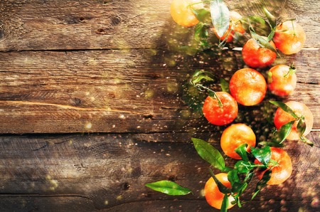 Mandarins Tangerines on wooden background. Copy space for your text. Bokeh and lights, toned effectの写真素材