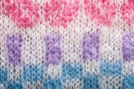 Knitted texture. Pattern fabric made of wool. Background, copy space.