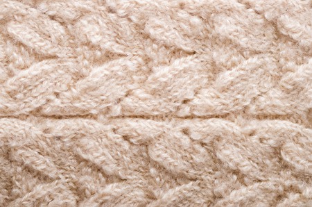 Knitted texture. Pattern fabric made of wool. Background, copy space.