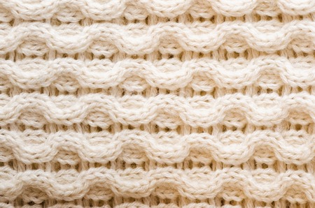 Knitted texture. Pattern fabric made of wool. Background, copy space.