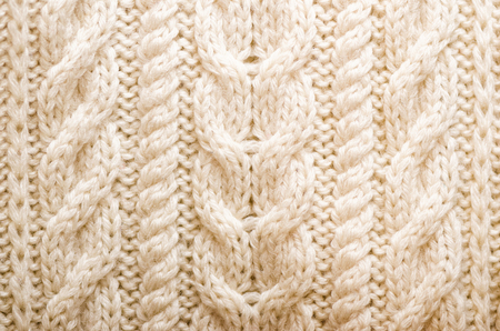 Knitted texture. Pattern fabric made of wool. Background, copy space.