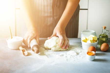 Heart of flour. Baking background with rolling pin, eggs, milk, butter on white kitchen table....