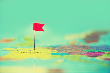 Red flag, pushpin, thumbtack pinned on map of europe.の写真素材