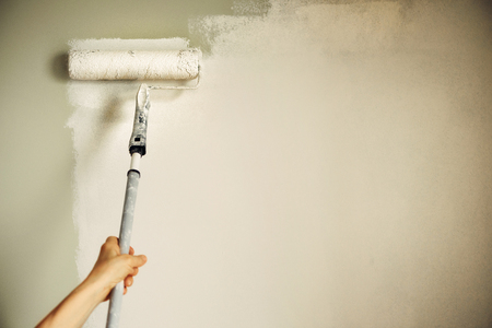 Hand painting wall with paint roller, pastel color.の写真素材