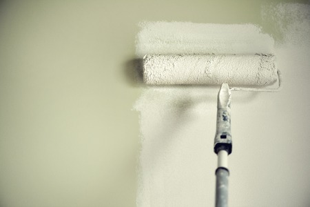 Hand painting wall with paint roller, pastel color.の写真素材