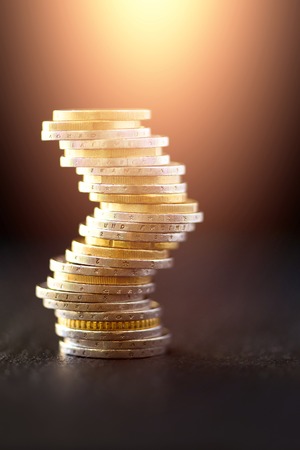 Euro money, currency. Success, wealth and poverty, poorness concept. Euro coins stack on dark black...