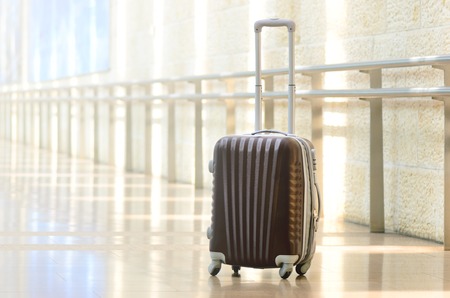 brown luggage in empty hall interior. Copy space.の写真素材