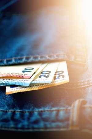 Euro banknotes in jeans pocket.の写真素材