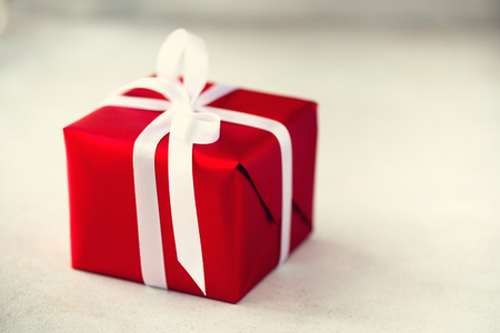 Red gift box on grey concrete background, copy space.の写真素材