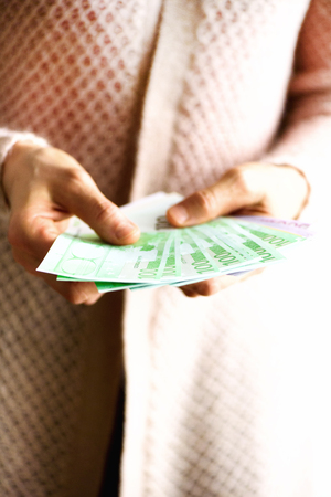 Woman hands holding euro currency money banknotes. Payment and cash concept. Copy space.の写真素材