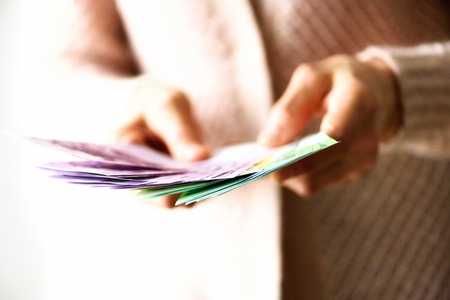Woman hands holding euro currency money banknotes. Payment and cash concept. Copy space.