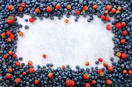 Food frame with mix of strawberry, blueberry. Top view. Vegan and vegetarian concept. Summer berries backgroundの写真素材