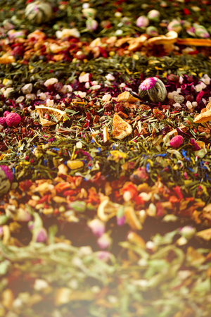 Different types of tea: green, black, floral, herbal, mint, melissa, rose, hibiscus, cornflower. Dry tea assortment with organic fruits, berries, ginger, orange, raspberry, cranberry. Top viewの写真素材