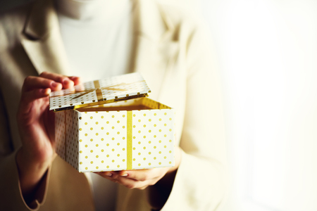 Female hands opening gift box, copy space. Christmas, hew year, birthday concept. Bannerの写真素材