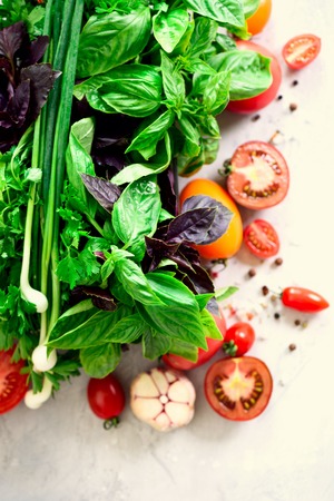 Green fresh aromatic herbs - thyme, basil, parsley on gray background. Food frame, border design. Copyspace. Top viewの写真素材