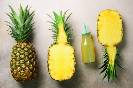 Pineapple and leaves on light blue background, top view, copy spaceの写真素材