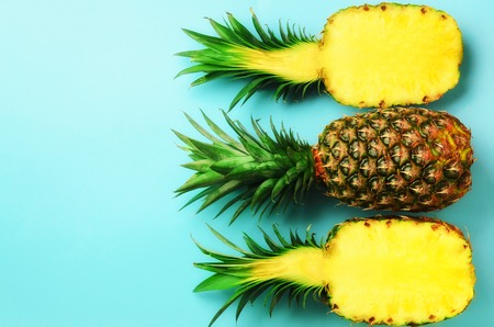 Pattern with bright pineapples on blue background. Top View. Copy Space. Minimal style. Pop art design, creative summer concept.の写真素材