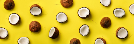 Pattern with ripe coconuts on yellow background. Top View. Copy Space. Pop art design, creative...
