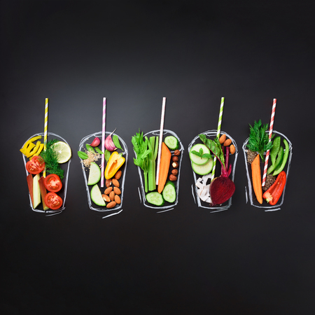 Food ingredients, organic vegetables for blending smoothie or juice on painted glass over black chalkboard. Top view with copy space. Square crop. Vegetarian, vegan, detox, clean eating concept.の写真素材