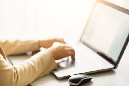 Woman working on computer close up. Woman hands typing on keyboard of laptop, online shopping...