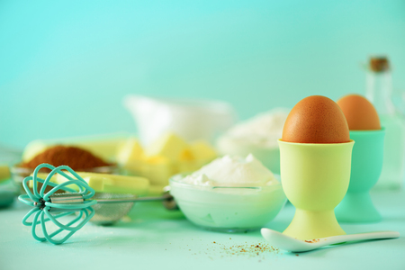 Turquoise cooking utensils on yellow background. Food ingredients. Macro of eggs. Cooking cakes and baking bread concept. Copy space.の写真素材