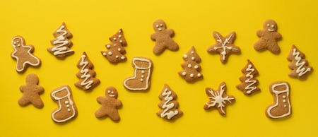 Christmas gingerbread cookies on yellow background.の写真素材