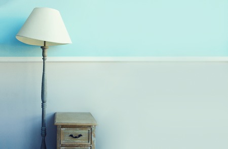 Floor torch lamp, wooden nightstand, curtains on pastel blue wall background. Banner with copy space. Minimalistic room interior. Ð¡hildrens room designの写真素材
