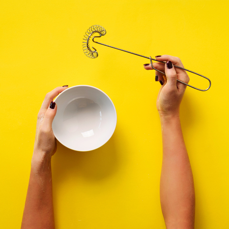 Female hands holding cooking equipment for meringueの写真素材