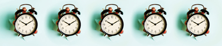 Seamless pattern of hands holding black alarm clock through hole in blue paper background. Wake up...
