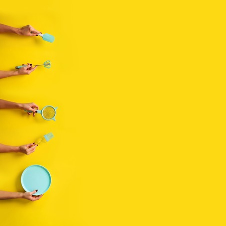 Hands holding kitchen tools holding kitchen toolsの写真素材