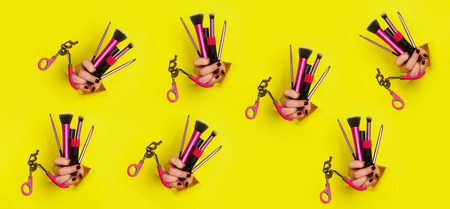 Pattern of woman hands with professional cosmetic tools for make upの写真素材