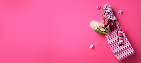 Fresh pink, white, violet hyacinth flowers in shopping bag on punchy pastelの写真素材