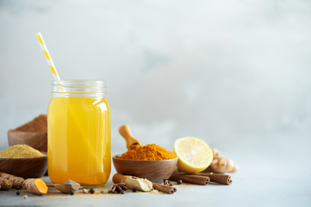 Lemon water with ginger, curcuma, black pepper. Vegan hot drink concept.の写真素材