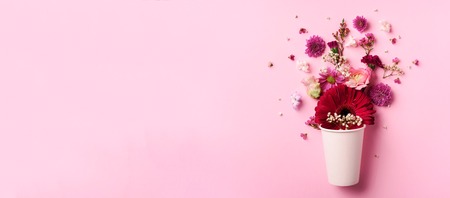 Creative layout made of white paper cup with pink flowers.の写真素材