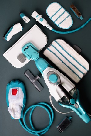 Set with modern professional steam cleaners on grey background. Top view, flat lay. Banner with copy space. Cleaning service concept.の写真素材